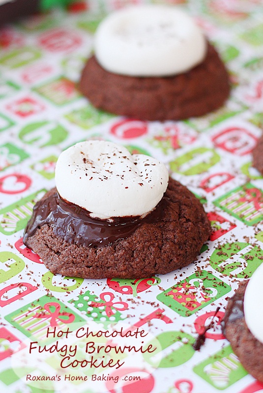 Hot chocolate fudgy brownie cookies topped with oozing chocolate and a gooey marshmallow. A delicious way to impress your loved ones. Recipe from Roxanashomebaking.com