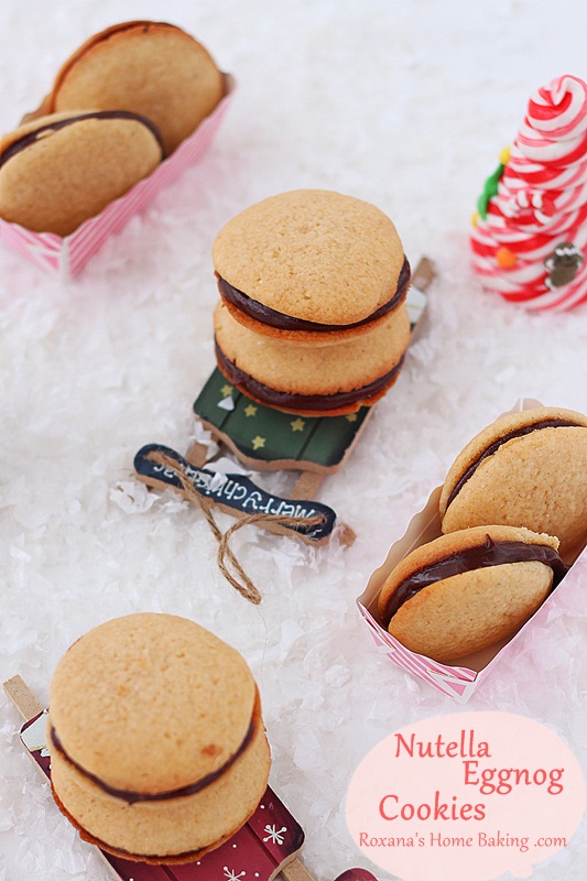 Nutella eggnog cookies recipe from Roxanashomebaking.com Eggnog flavored soft cookies with crisp edges sandwiched with eggnog nutella. Great for your holiday table or for cookie exchange. 