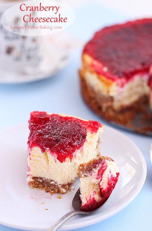 A creamy velvety cheesecake topped with cranberry sauce. Recipe roxanashomebaking.com