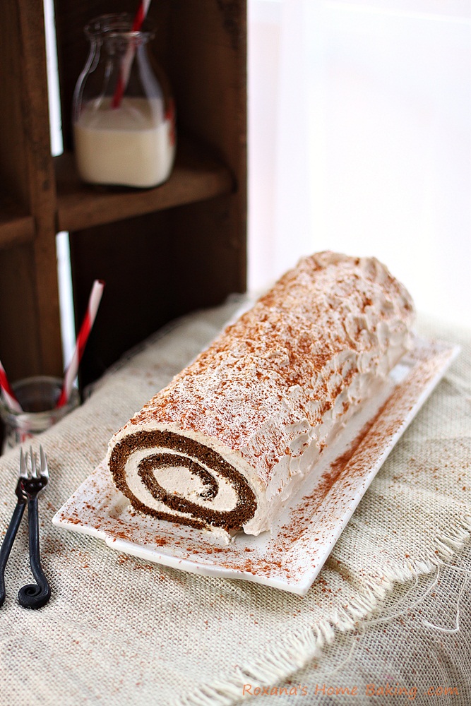 Moist gingerbread roll cake filled with spiced creamy filling from Roxanashomebaking.com A delicious twist on the traditional Christmas gingerbread cake 