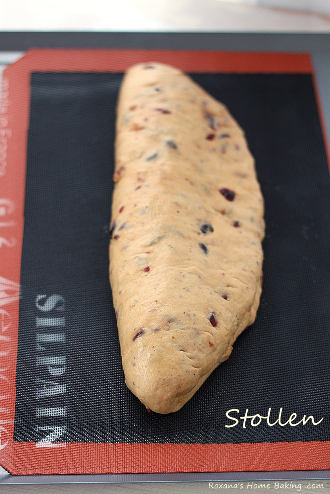 A sweet German yeast bread, stollen is packed with rum soaked fruit and marzipan and dusted with powder sugar for a winter look.