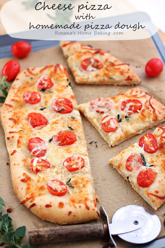 Made-from-scratch flavorful cheese pizza dough topped with more cheese and grape tomatoes. Friday night pizza just got a whole lot better! Recipe from Roxanashomebaking.com