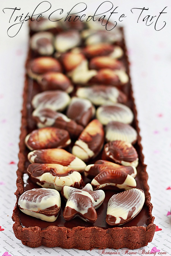 Triple chocolate tart – chocolate crust filled with smooth, shiny, rich chocolate ganache and topped with Belgian chocolate seashells