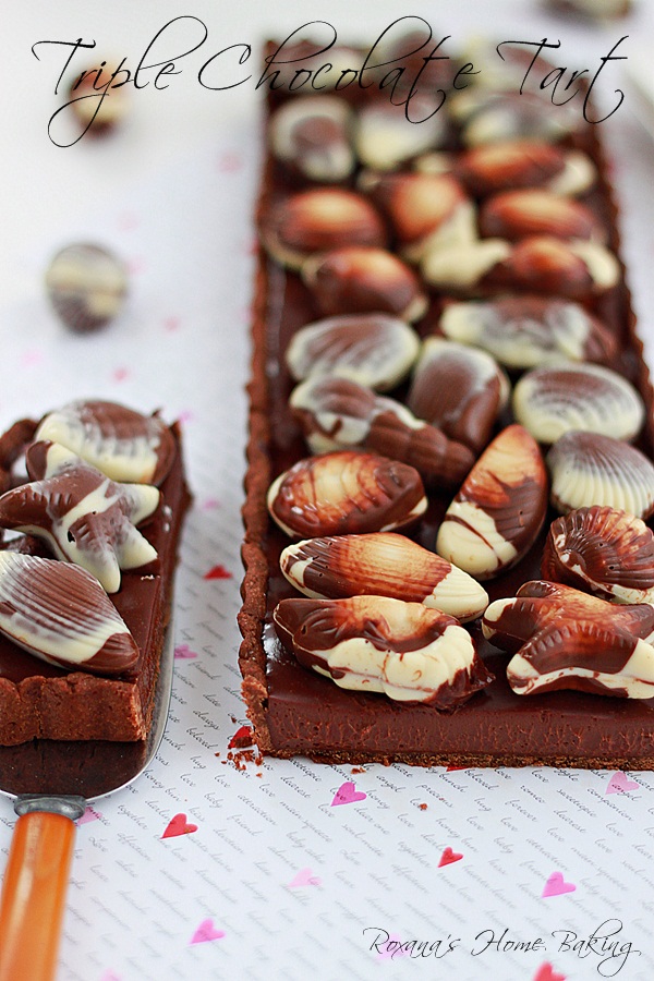 Triple chocolate tart from Roxanashomebaking.com chocolate crust filled with smooth, shiny, rich chocolate ganache and topped with Belgian chocolate seashells