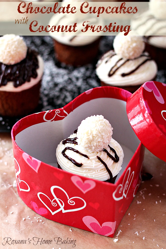 Chocolate cupcakes flavored with Almond Joy coffee creamer and topped with silky smooth coconut frosting and a Raffaello Almond Coconut candy from Roxanashomebaking.com