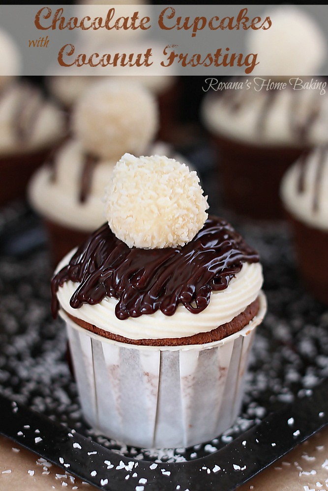 Chocolate cupcakes flavored with Almond Joy coffee creamer and topped with silky smooth coconut frosting and a Raffaello Almond Coconut candy from Roxanashomebaking.com