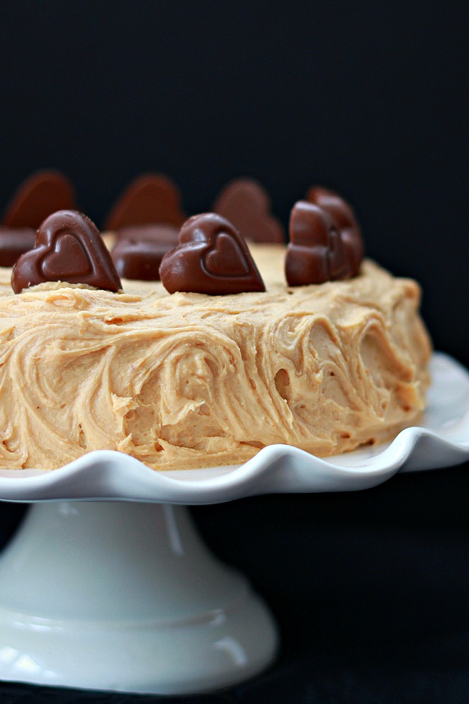 Light peanut butter cake with the best peanut butter frosting and chopped peanut butter cups. Deliciousness in every bite.