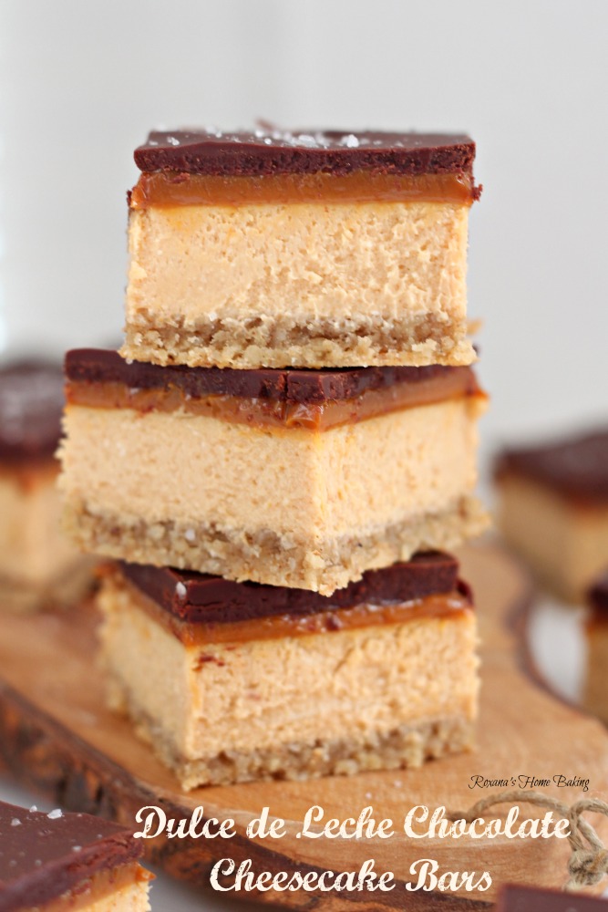 Dulce de leche chocolate cheesecake bars from Roxanashomebaking.com Rich creamy caramel-y cheesecake topped with a thin layer of dulce de leche and chocolate ganache and a sprinkle of fleur de sel. The perfect sweet and salty treat!