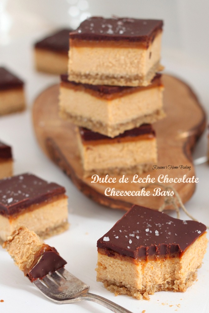 Dulce de leche chocolate cheesecake bars from Roxanashomebaking.com Rich creamy caramel-y cheesecake topped with a thin layer of dulce de leche and chocolate ganache and a sprinkle of fleur de sel. The perfect sweet and salty treat!