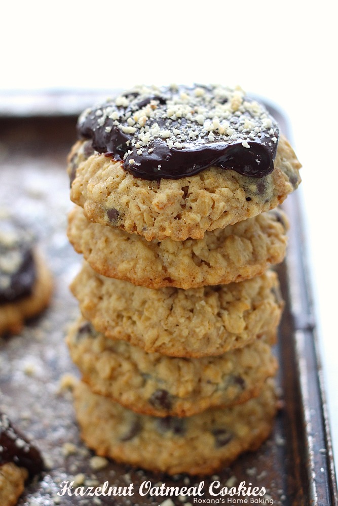 Thick chewy oatmeal cookies with crispy edges packed with rolled oats, chopped hazelnuts and chocolate chips and topped with chocolate ganache. A classic lunch box treat make-over