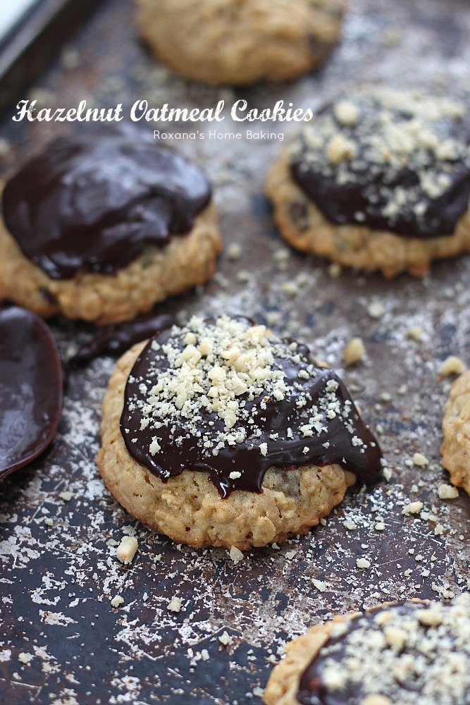 Thick chewy oatmeal cookies with crispy edges packed with rolled oats, chopped hazelnuts and chocolate chips and topped with chocolate ganache. A classic lunch box treat make-over