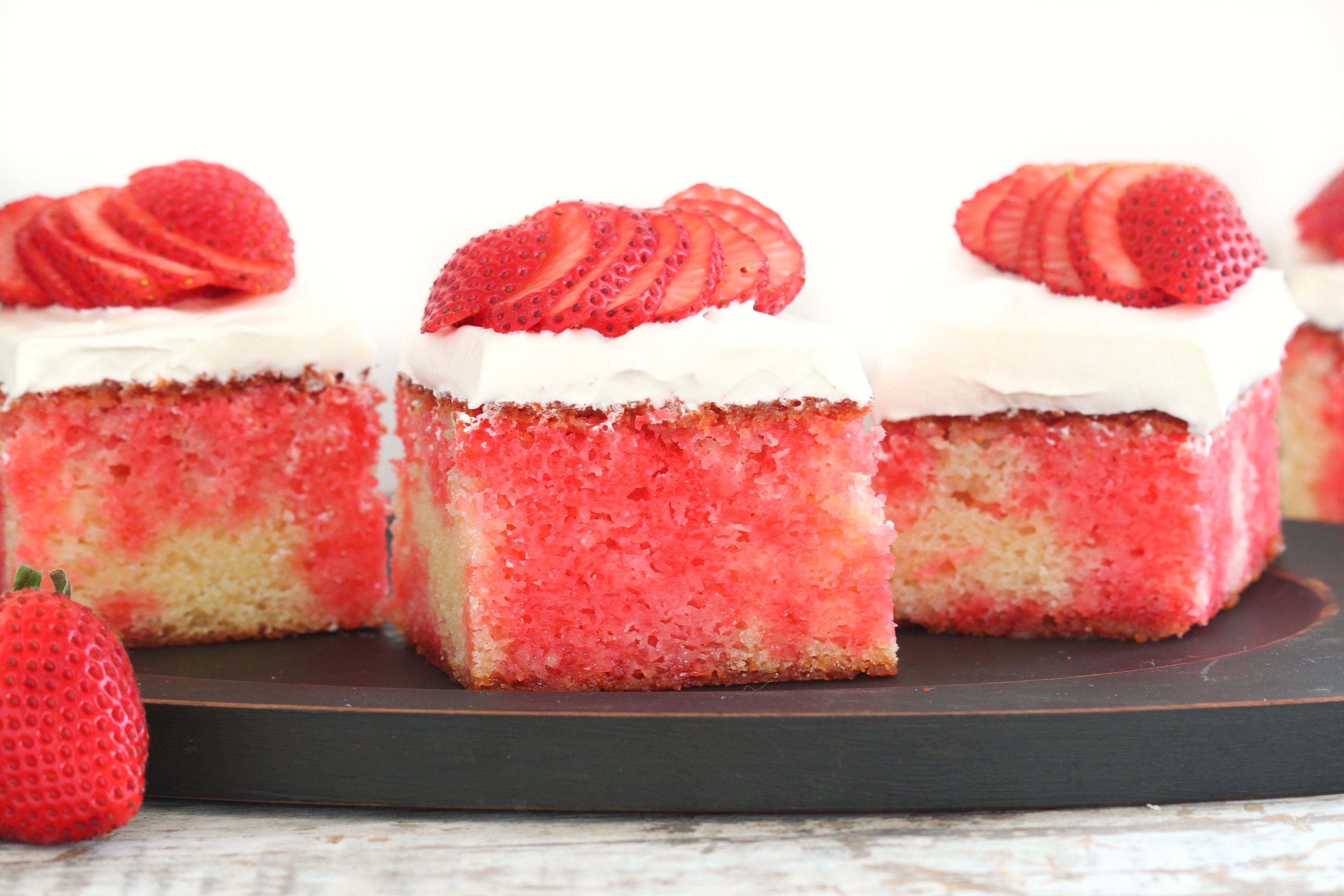 With its pretty red stripes, this made-from-scratch poke cake drenched in s...
