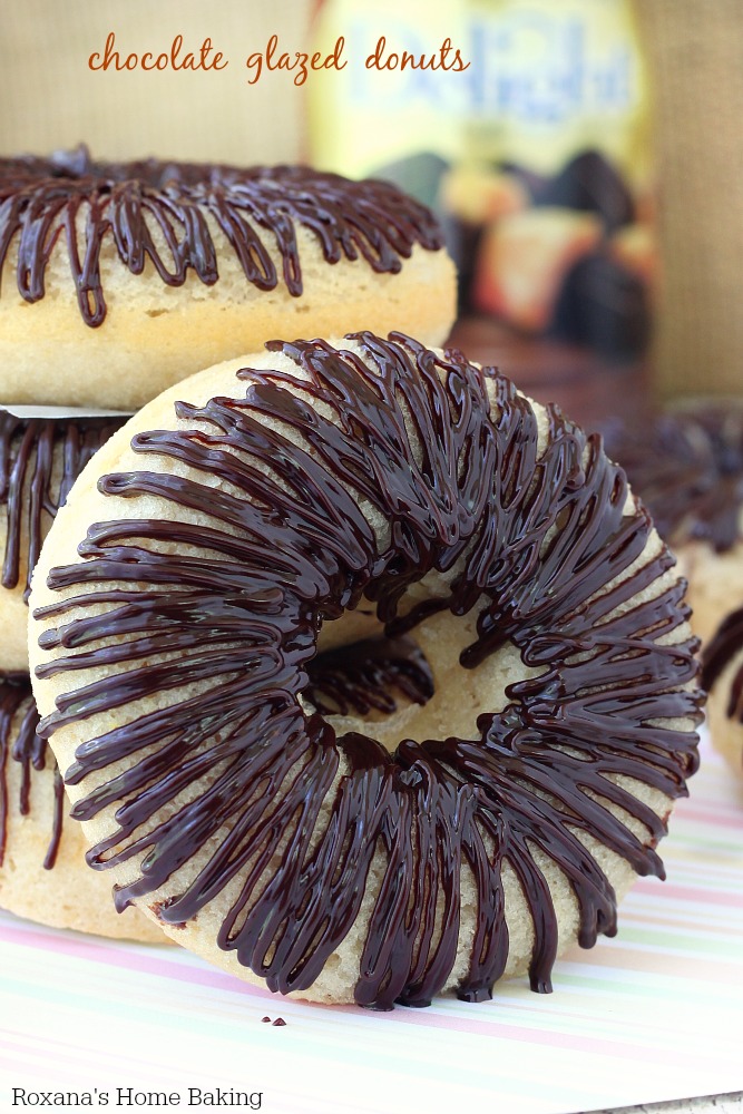 Soft, fluffy, cake like baked donuts topped with a bittersweet chocolate ganache are the perfect excuse to enjoy chocolate for breakfast. Recipe from Roxanashomebaking.com