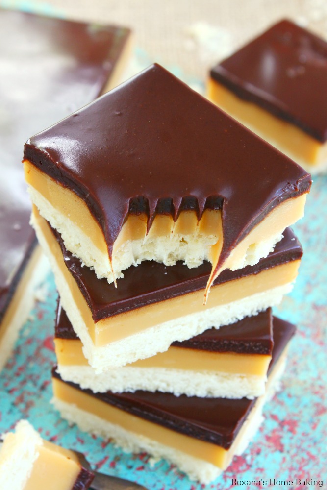 Buttery cookie base, a layer of decadent smooth caramel and a rich chocolate ganache - this homemade version of the well known Twix® bars comes together in less than 1 hour and makes enough to feed a crowd!