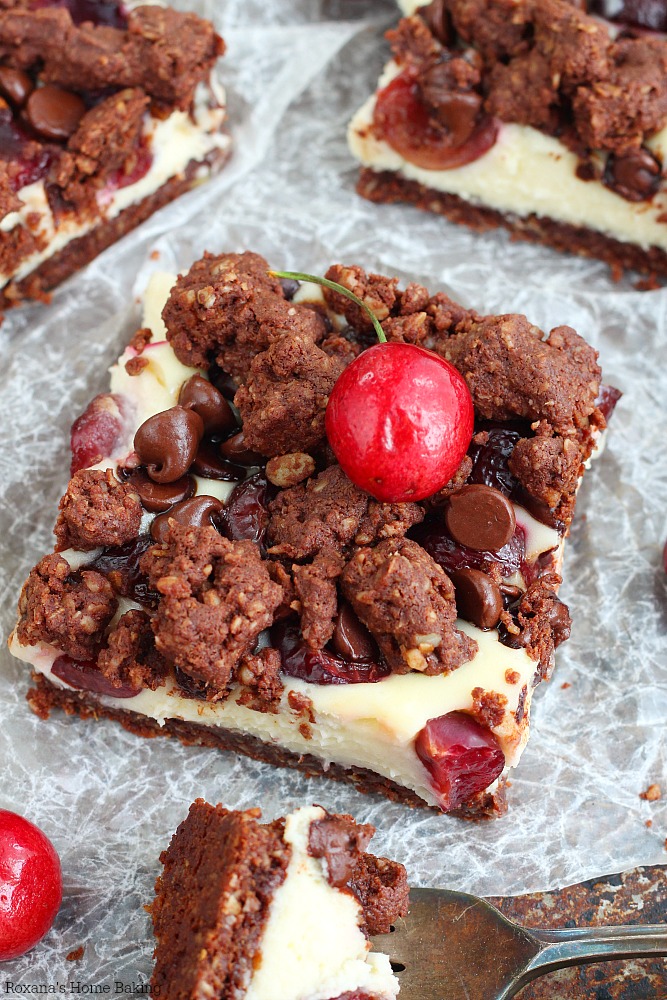 Sandwiched between a chocolate crust and chocolate crumble topping , these creamy dreamy chocolate cherry cheesecake bars are loaded with fresh cherries and chocolate chips 