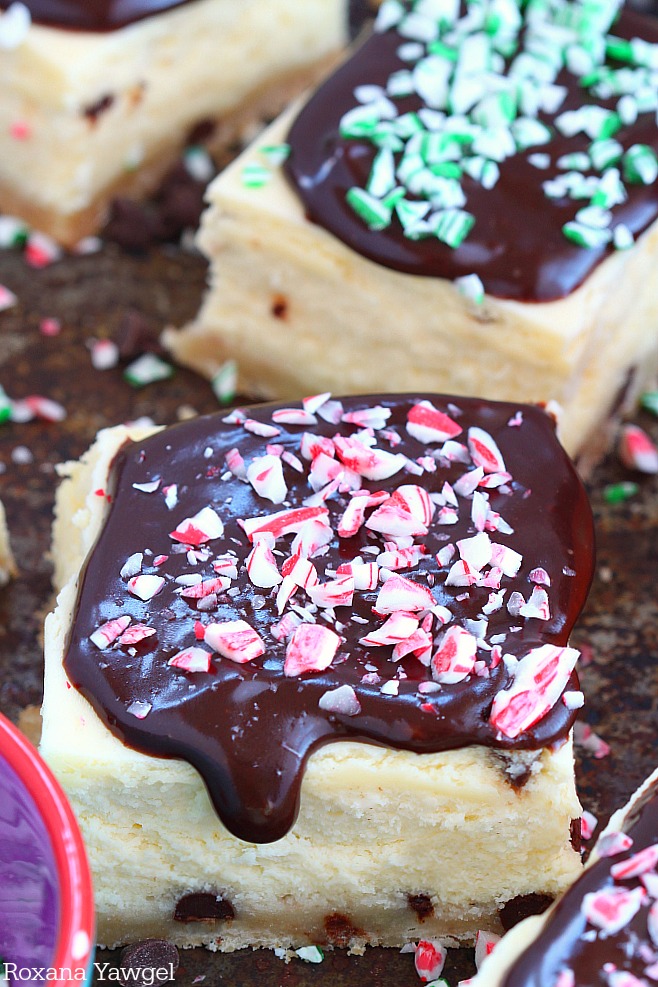 Quick and easy peppermint chocolate chip cheesecake bars featuring a buttery crust, silky cheesecake filling dotted with mini chocolate chips and a rich chocolate ganache with crushed candy cane on top! A scrumptious treat dressed up for your holiday table!