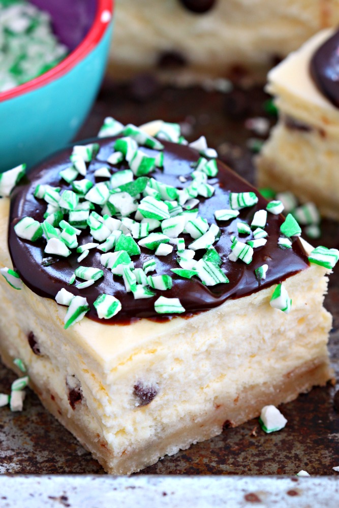 Quick and easy peppermint chocolate chip cheesecake bars featuring a buttery crust, silky cheesecake filling dotted with mini chocolate chips and a rich chocolate ganache with crushed candy cane on top! A scrumptious treat dressed up for your holiday table!