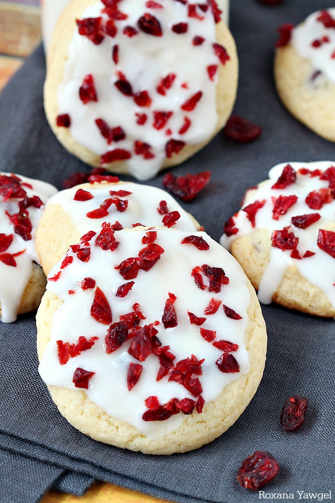 Delicious holiday cookies, these orange cranberry cookies are infused with orange zest and dried cranberries, then topped with an easy orange icing and more cranberries. 