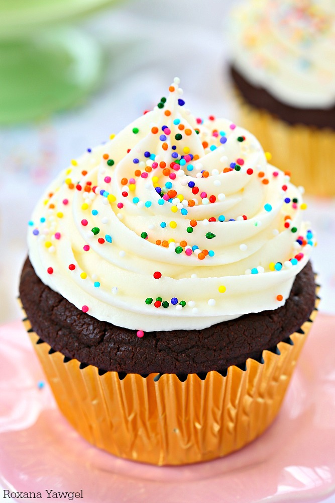 So soft, fluffy, and full of chocolate flavor in every bite, these sugar cookie chocolate cupcakes are piled high with cream cheese frosting and finished with colorful sprinkles! 